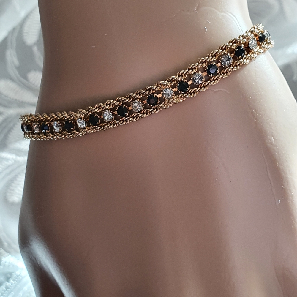 Black and clear double chain tennis bracelet. Gold chain 2 strands.